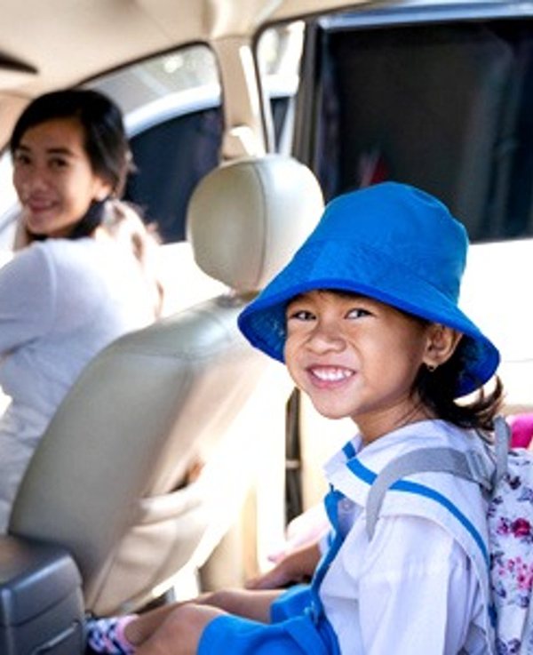Student smiling in the back seat of an Ospace ride