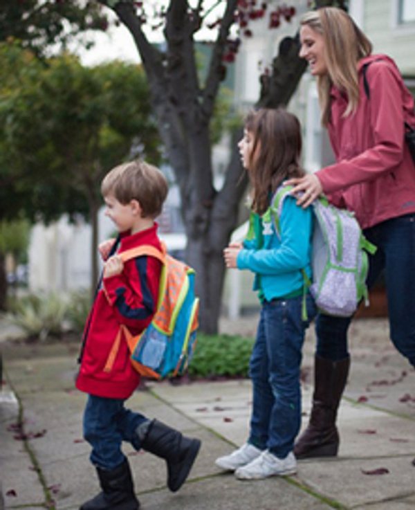 Parent walking students to their Ospace ride