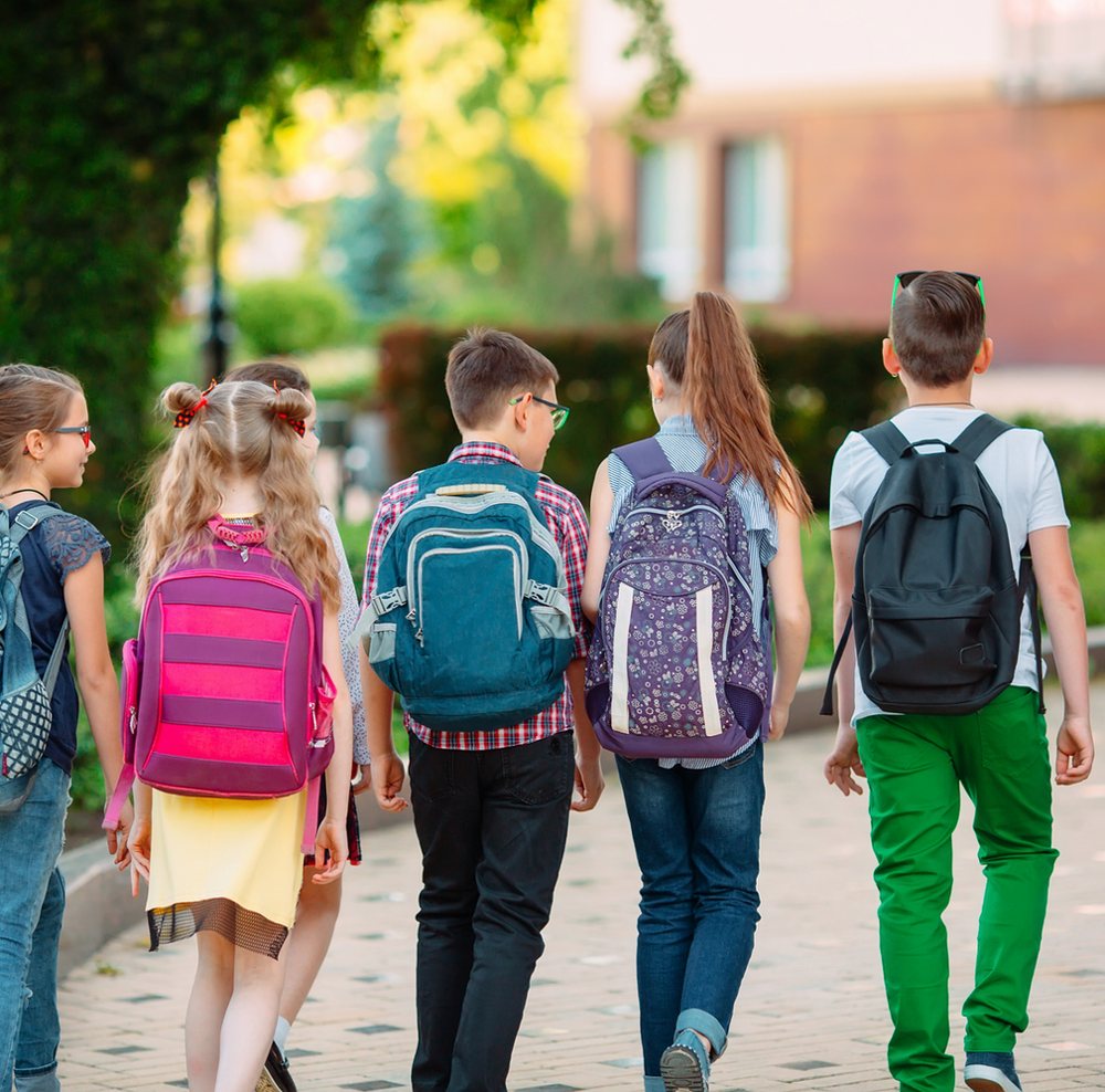 Students walking to school with backpacks